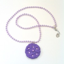 purple floral rhinestone medallion with plastic pearl garland string