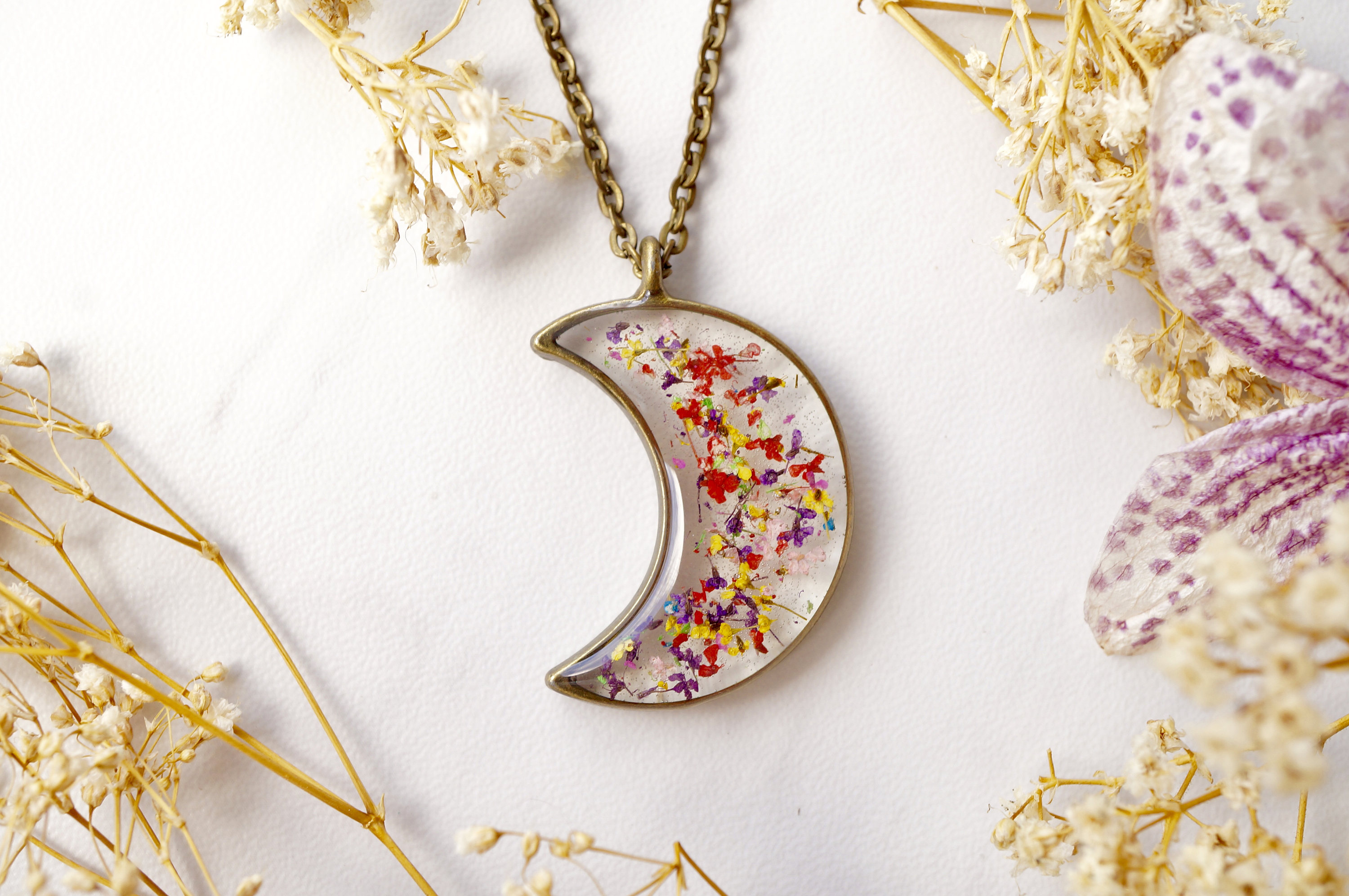 real dried flowers and resin moon necklace in red yellow purple